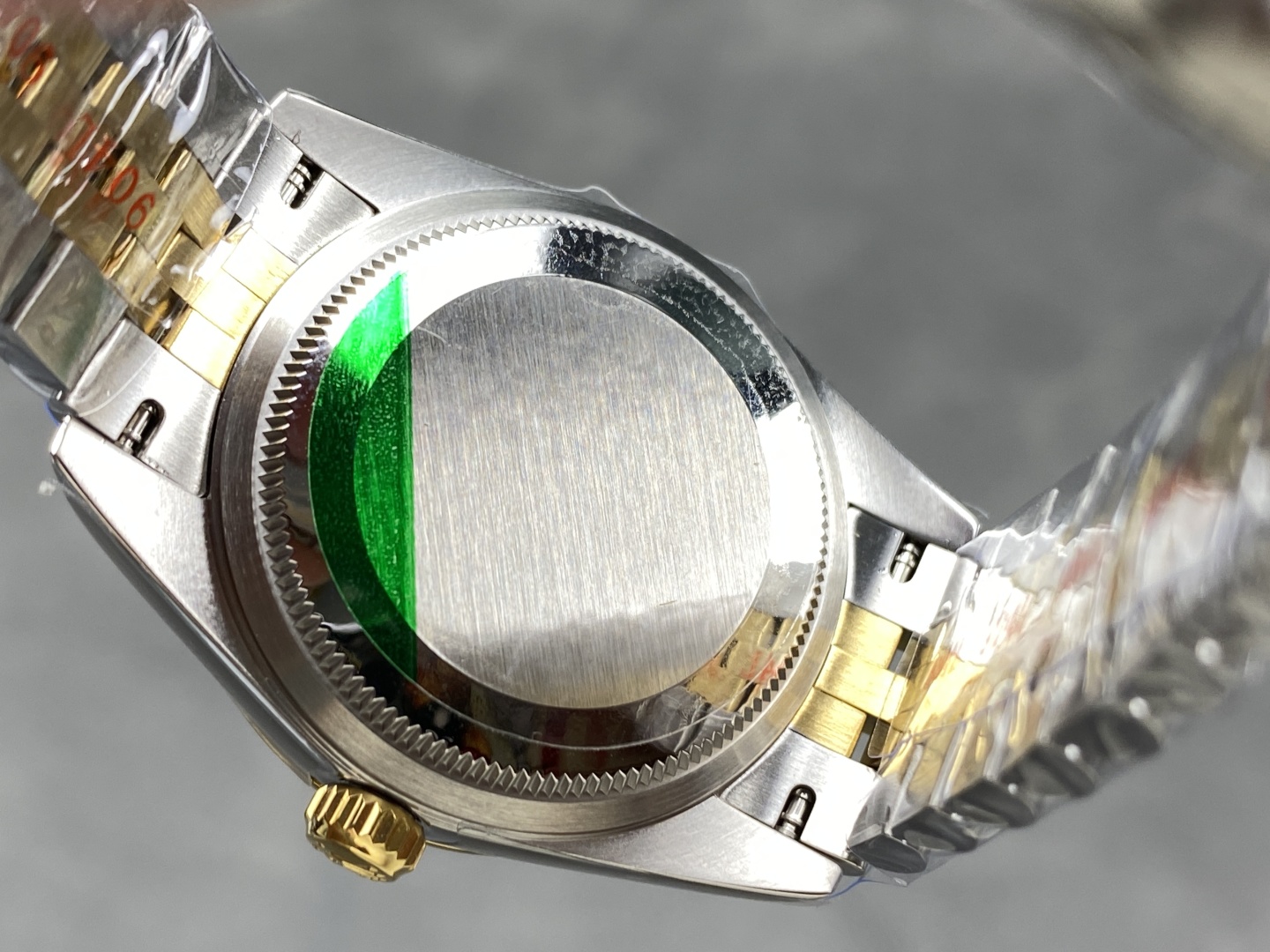 Replica rolex case back with green protective sticker and brushed finish