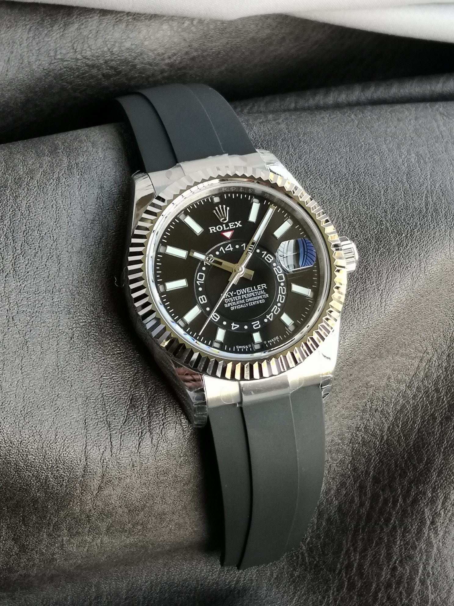 Close-up shot of the black dial with luminous markers and red triangle indicator