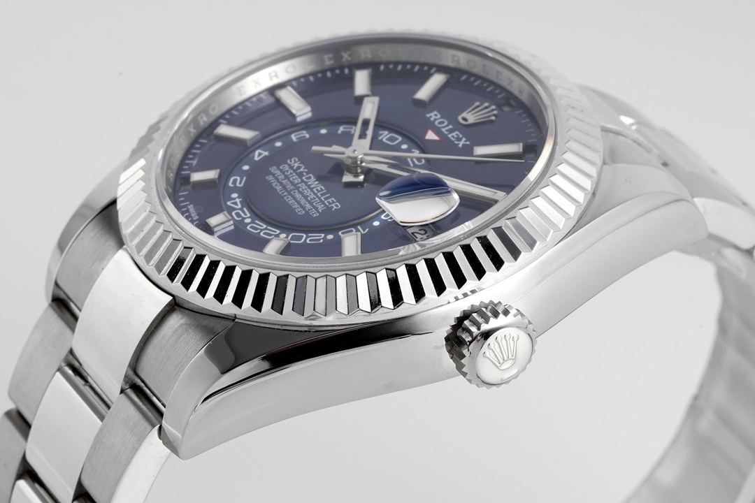 Close-up of Rolex Sky-Dweller fluted bezel with ROLEX inscription and polished crown