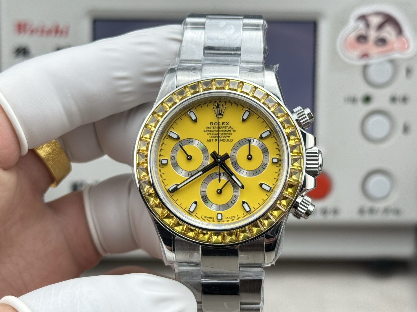Close-up of custom yellow Rolex Daytona replica with faceted pyramid gemstone bezel and vibrant sunburst dial held by gloved hand