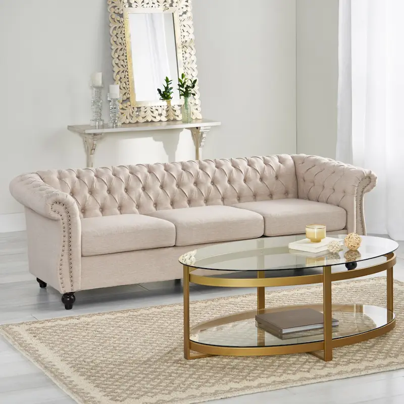 Beige tufted three-seater sofa, adorned with rivets