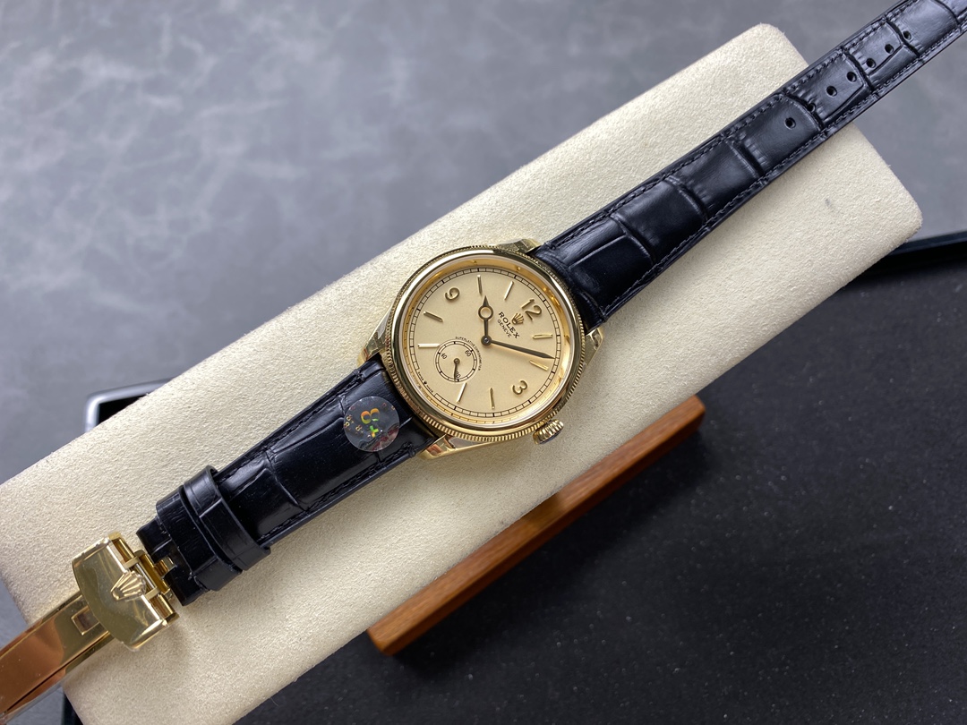 Rolex replica full view with black leather strap and gold case on display cushion