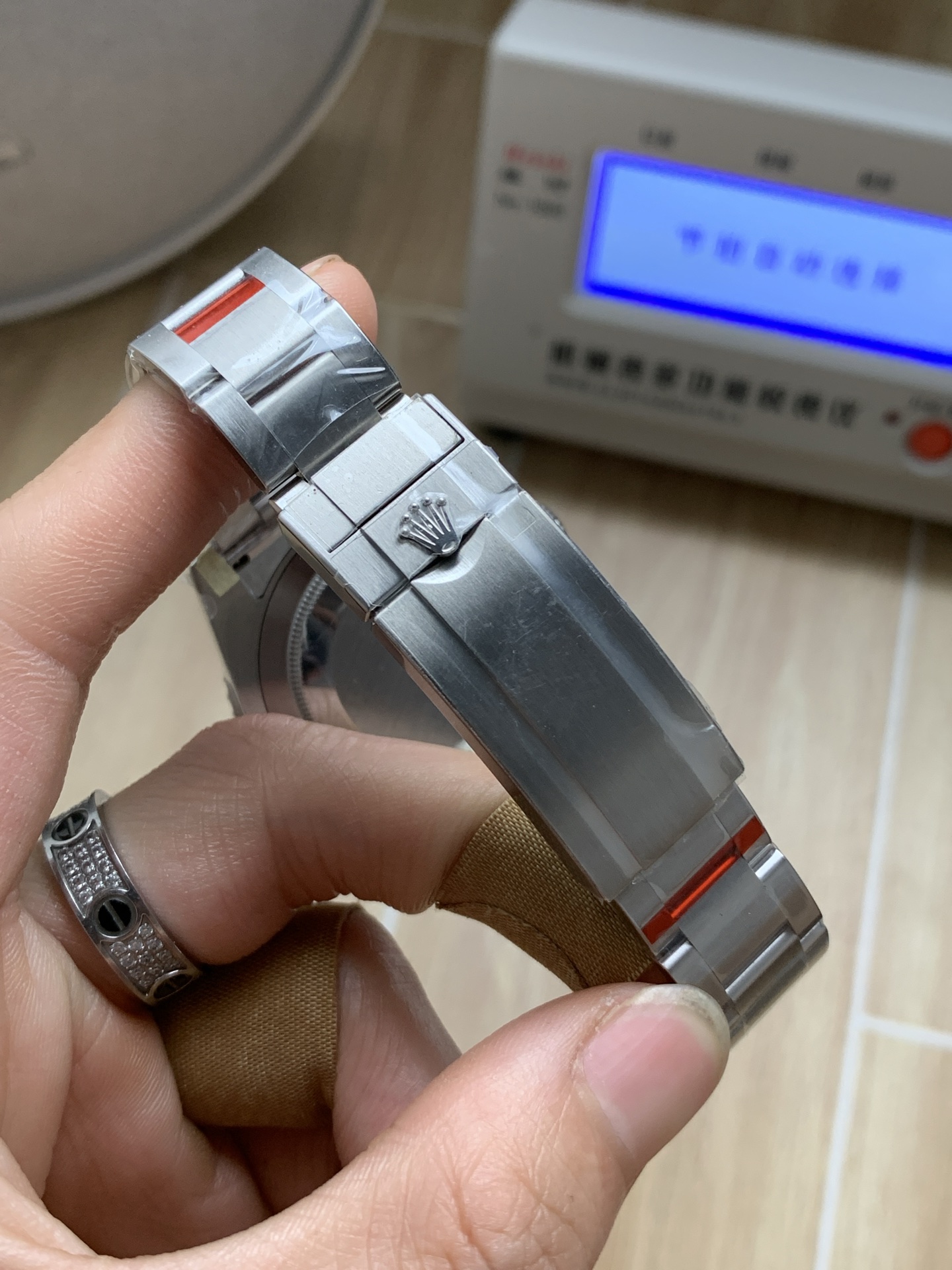 Replica Rolex clasp close-up showing brushed steel finish and coronet detail