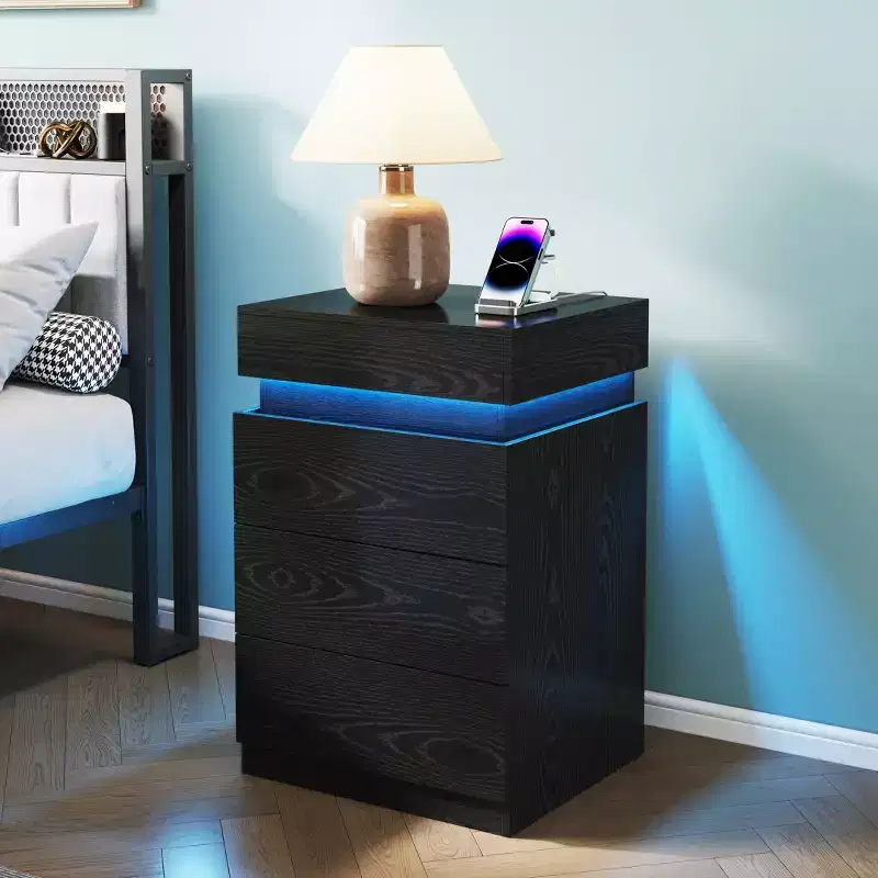 Nightstand with Built-In Charging Station and LED Lighting, 3-Drawer Sliding-Top Modern Bedside Table, Black Wooden End Table is a modern.