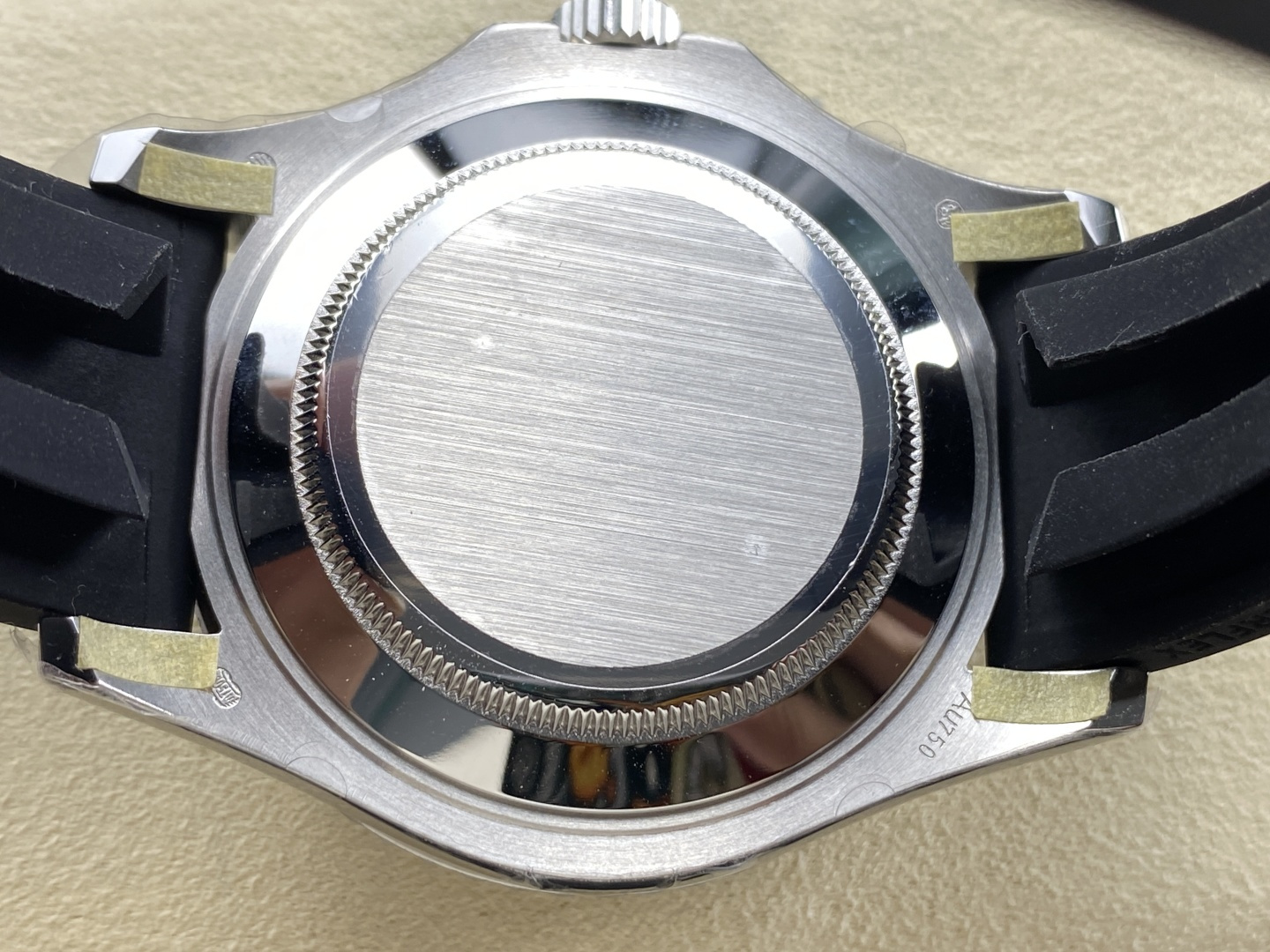 Case back of imitation rolex watch showing brushed steel and engravings