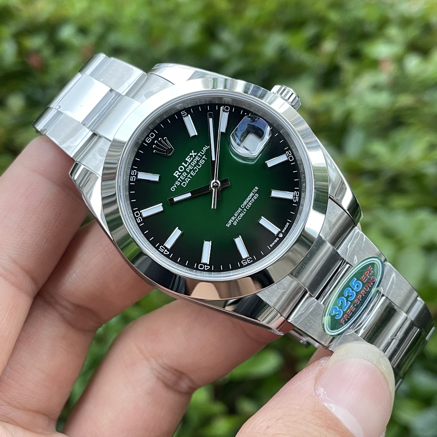 Rolex DateJust replica with a green dial and Oyster bracelet showing the 3235 movement sticker