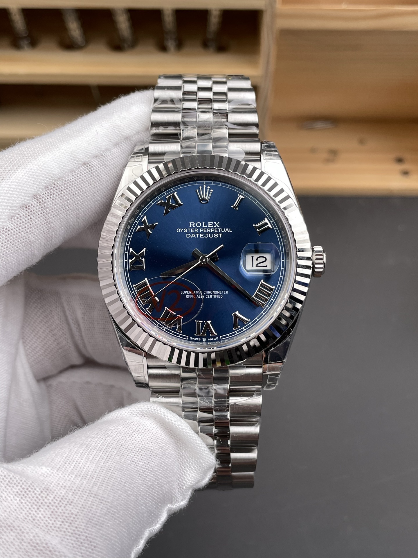 Rolex Datejust replica with blue dial, fluted bezel, and Jubilee bracelet front view