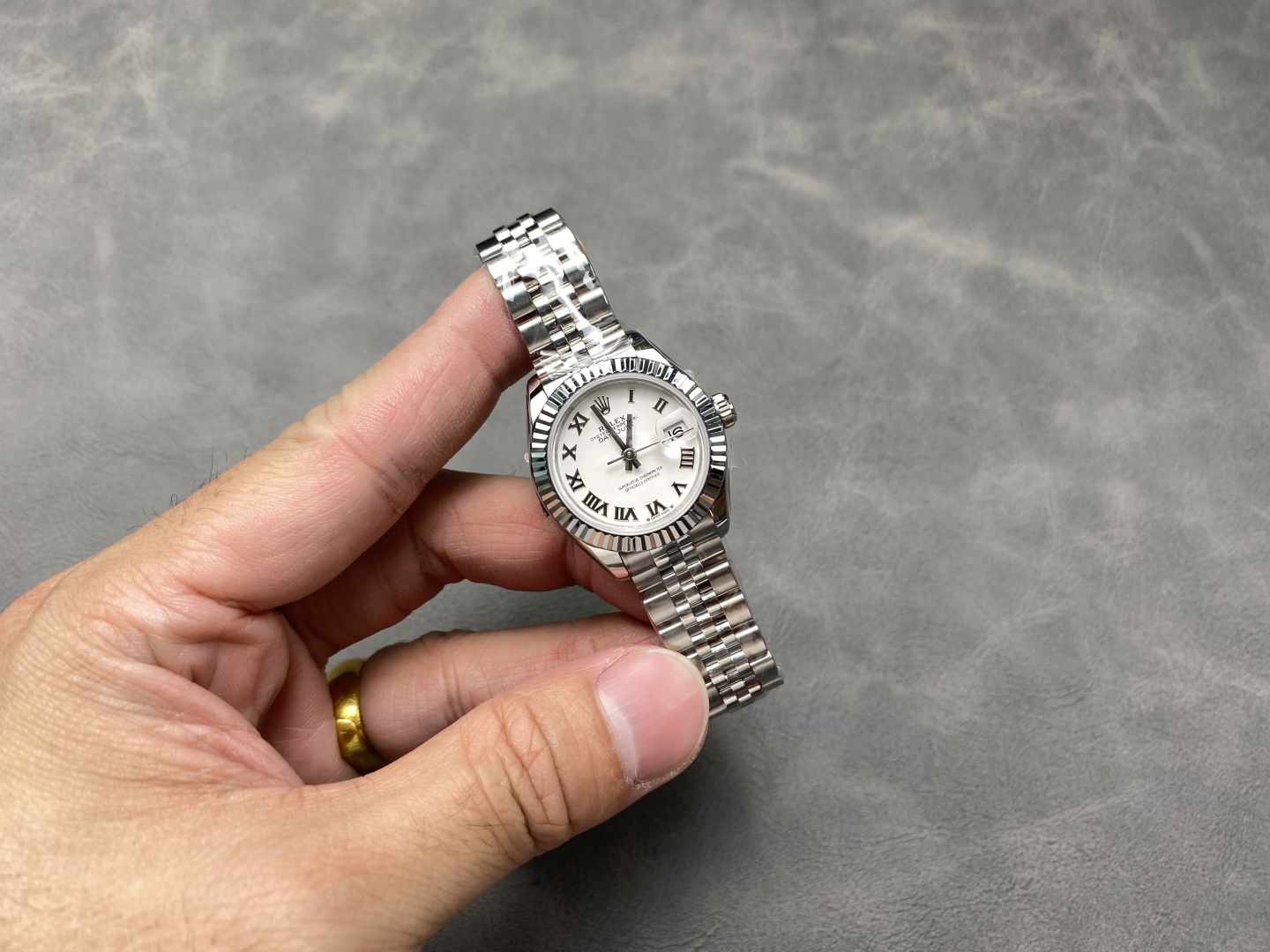 Holding a quality rolex super clone Datejust 36 in hand