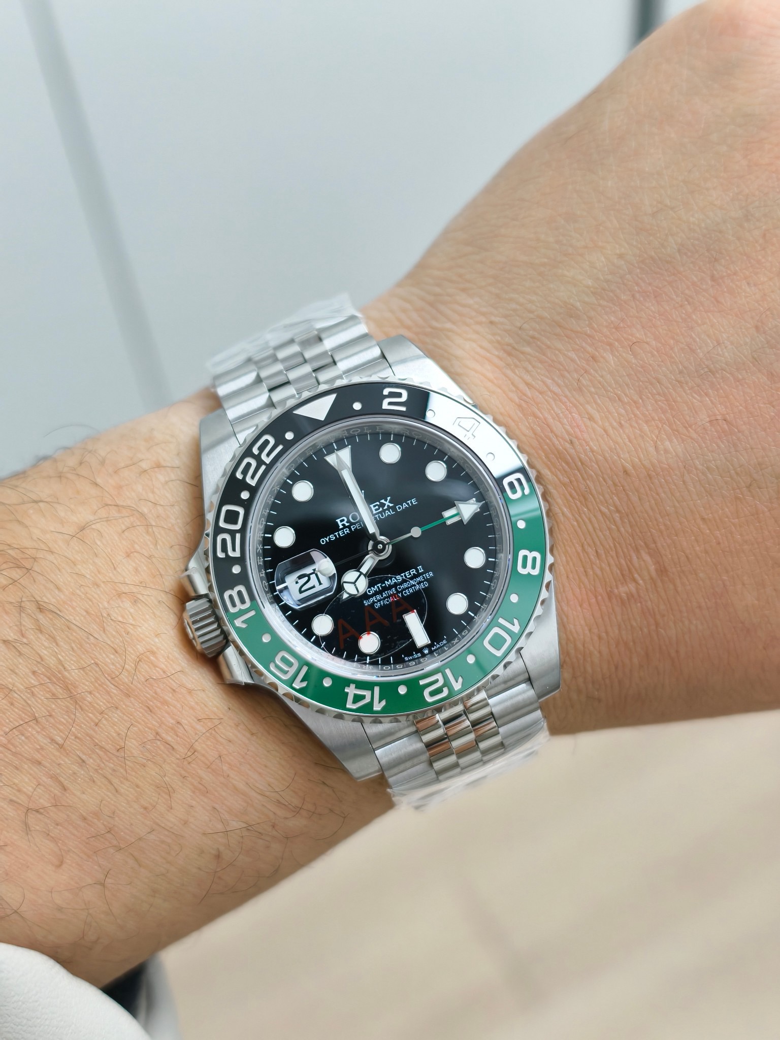 Rolex GMT-Master II replica on wrist with black and green bezel and Jubilee bracelet