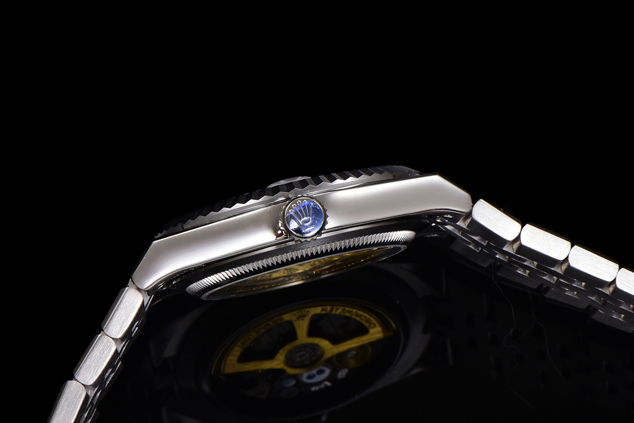 Side profile of a silver Rolex copy watch with fluted bezel and visible crown