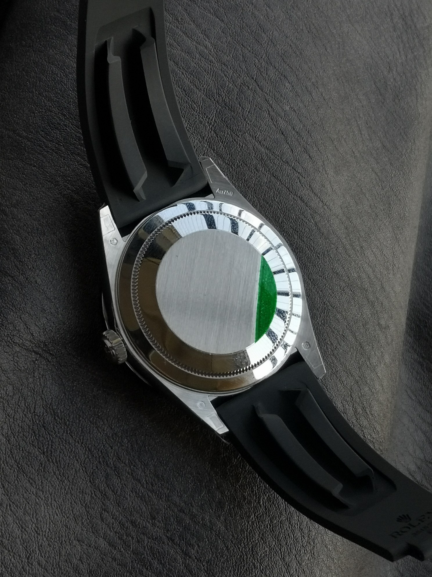 Solid case back of replica Rolex Sky-Dweller with green sticker