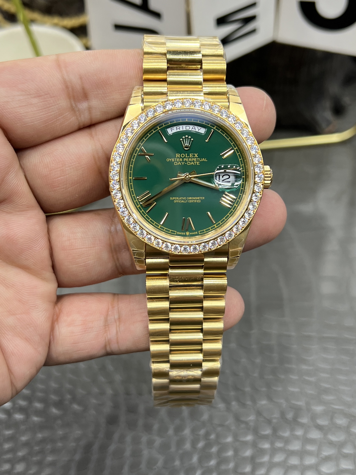 Detailed front view of the Rolex replica Day-Date showing green dial with day window displaying FRIDAY and date cyclops lens