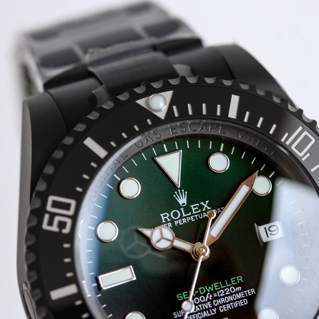 Close-up macro shot of Rolex Sea-Dweller dial with green sunburst finish and indices