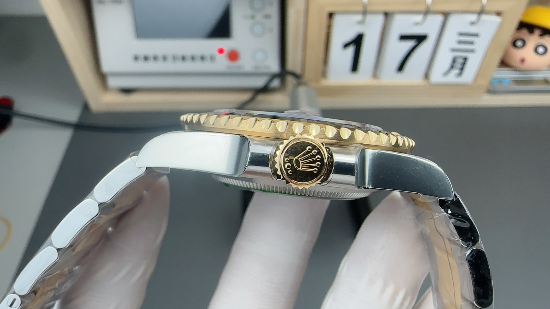 Side profile of two tone replica Rolex Submariner showing crown case thickness and bezel edge