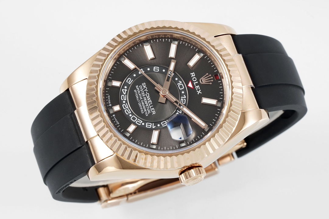 Angled view of a gold fake Rolex Sky-Dweller showing the dial details and the Oysterflex strap connection
