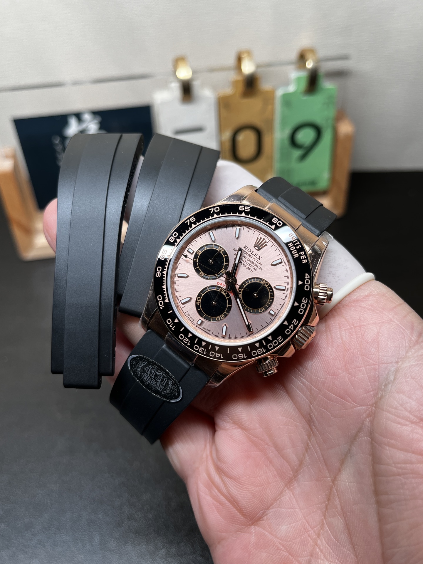 Rose gold Daytona replica watch with pink dial and extra black rubber straps