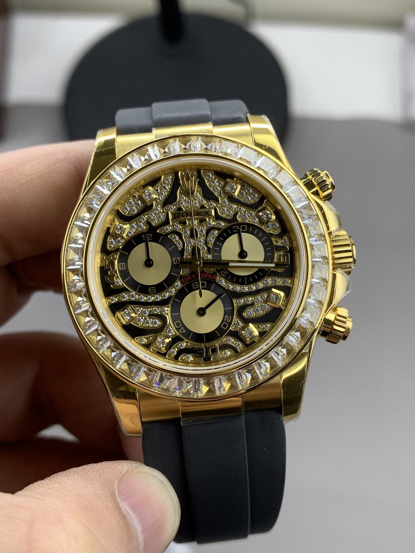 Gold and diamond-set replica Rolex Daytona with black rubber strap and 4130 clone movement