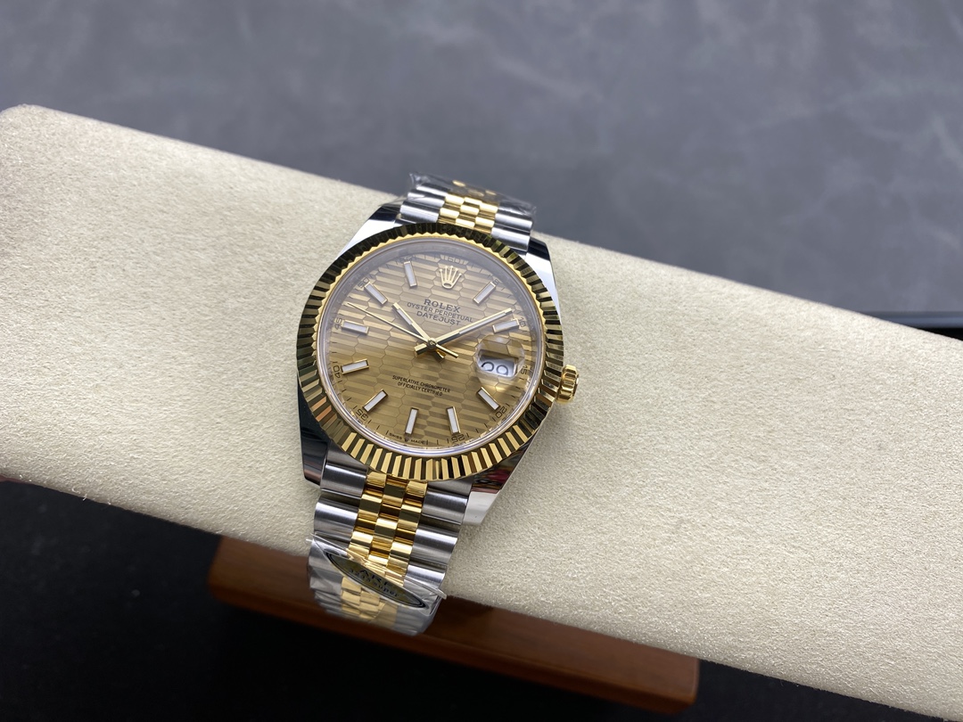 Two tone Datejust replica watch with gold dial on a display cushion