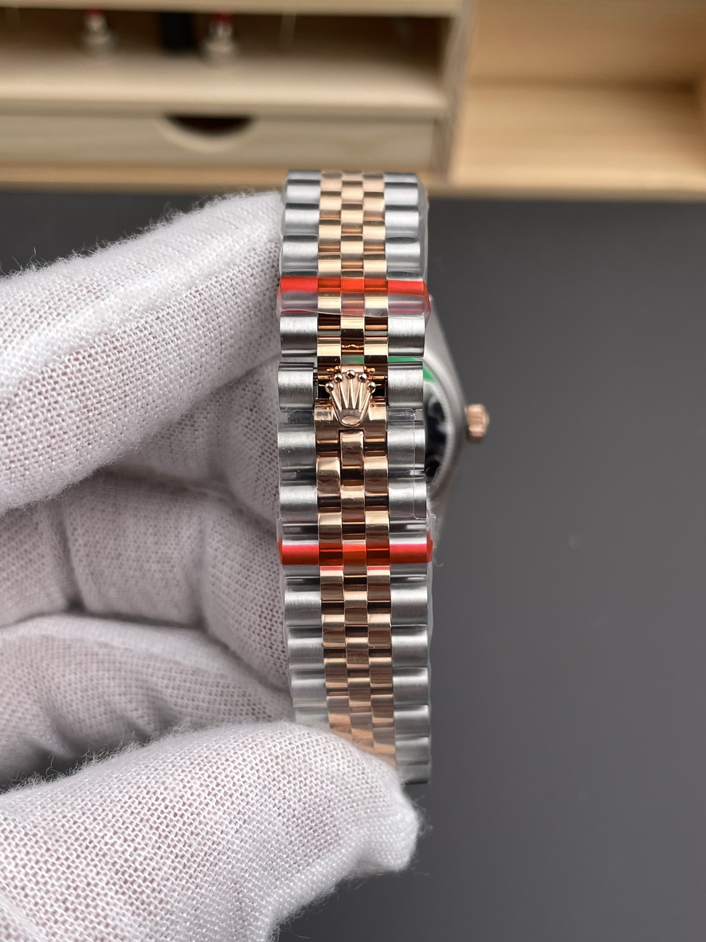 Close bracelet view of two tone Rolex replica Jubilee bracelet and clasp crown logo
