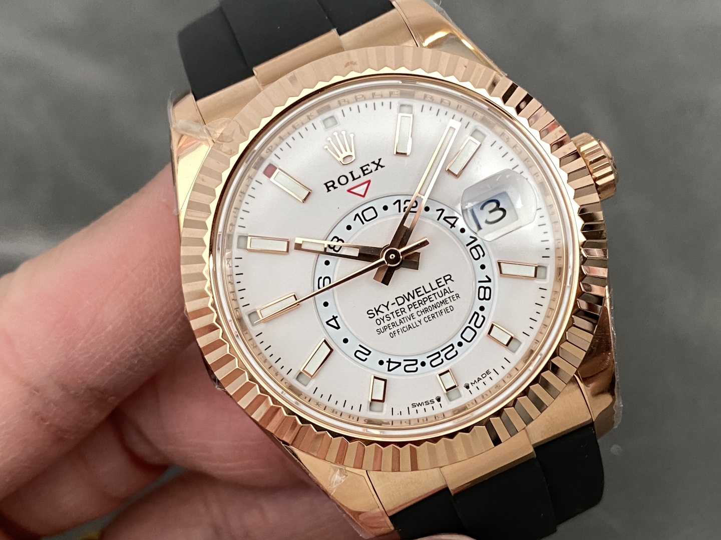 Premium rose gold Rolex Sky-Dweller replica with elegant white dial featuring 24-hour subdial and date window