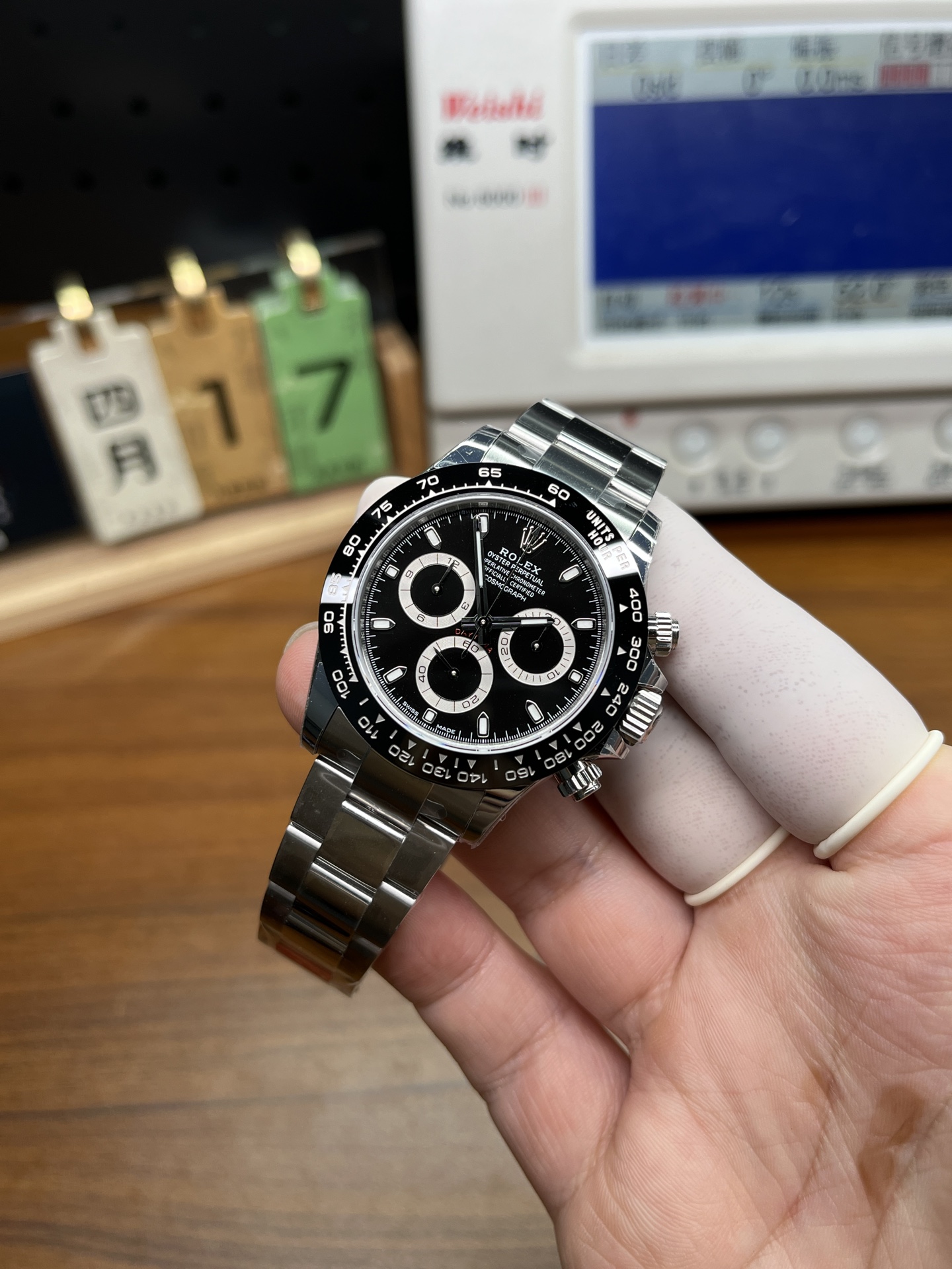 Rolex Daytona black dial replica in hand front angle