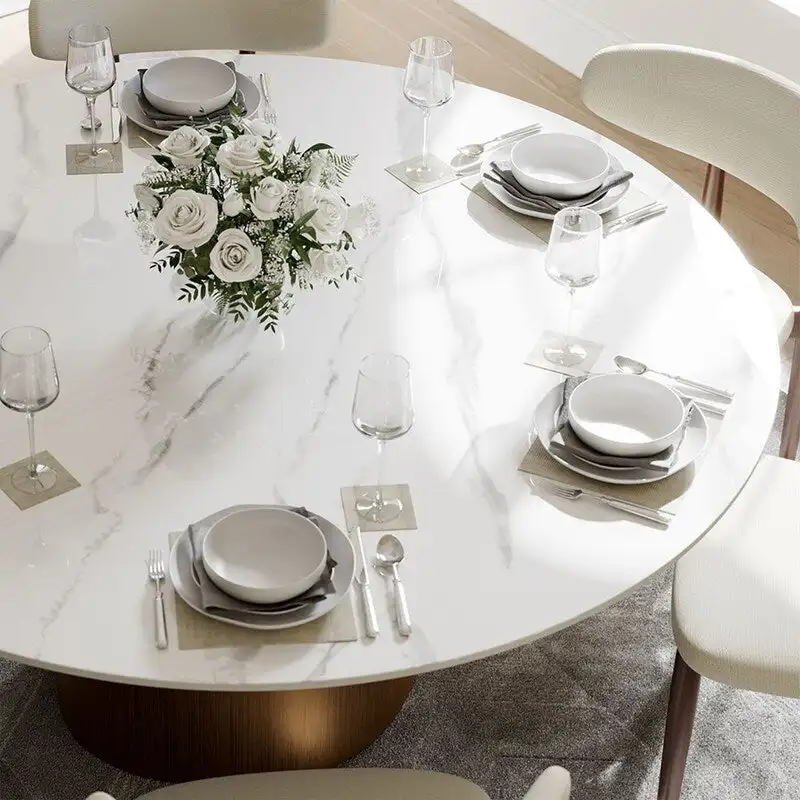 Modern Round Dining Table – White Sintered Stone Top & Bronze Carbon Pedestal