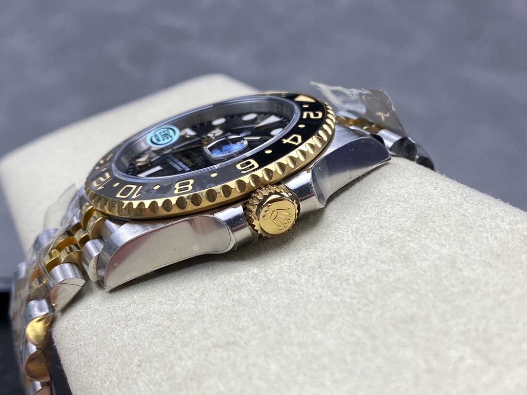 Side profile of the two-tone stainless steel and gold Rolex-style watch showing the fluted crown and Jubilee bracelet links