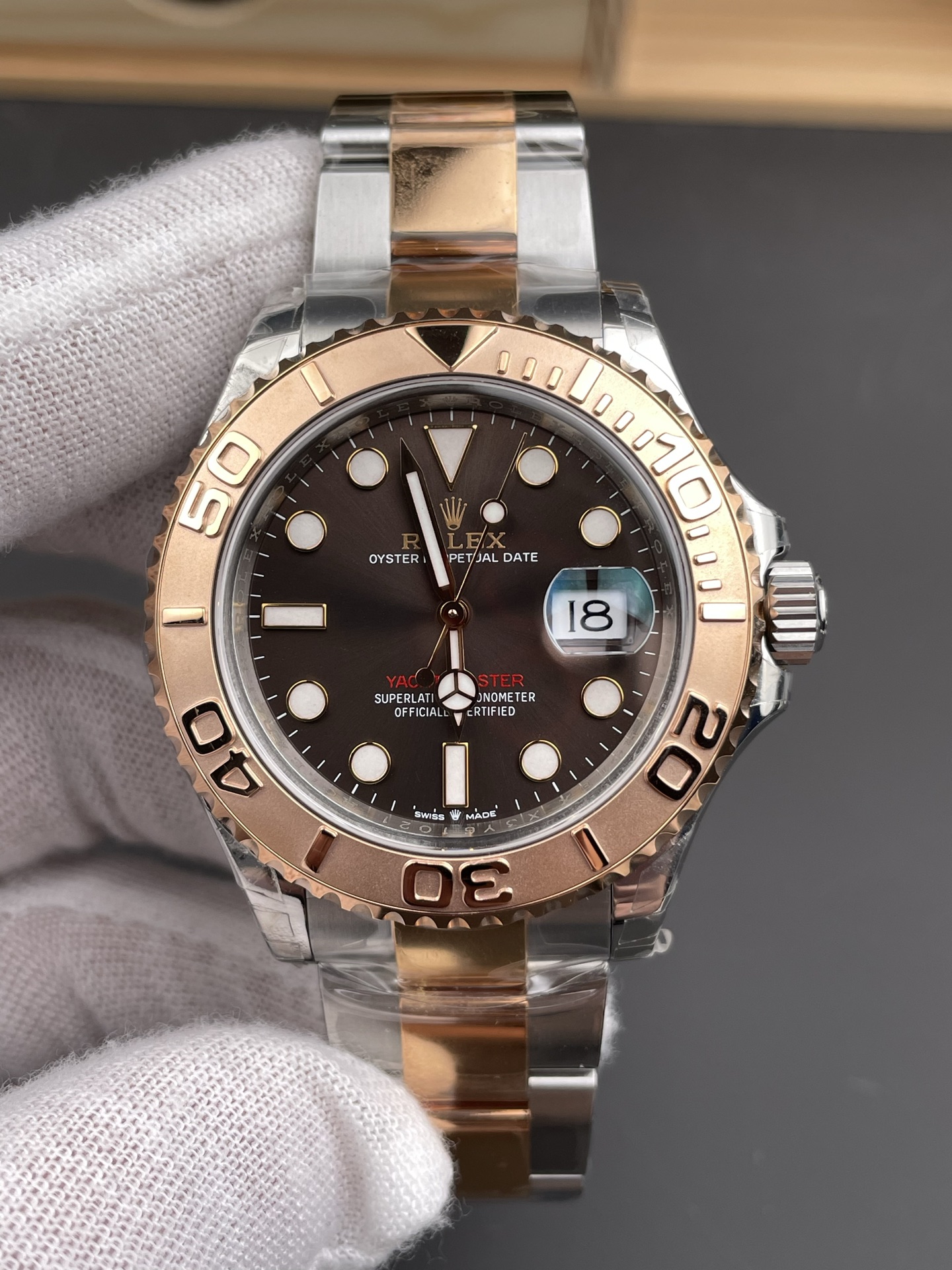Front view of rose gold and steel Rolex Yacht-Master replica with brown dial and date magnifier