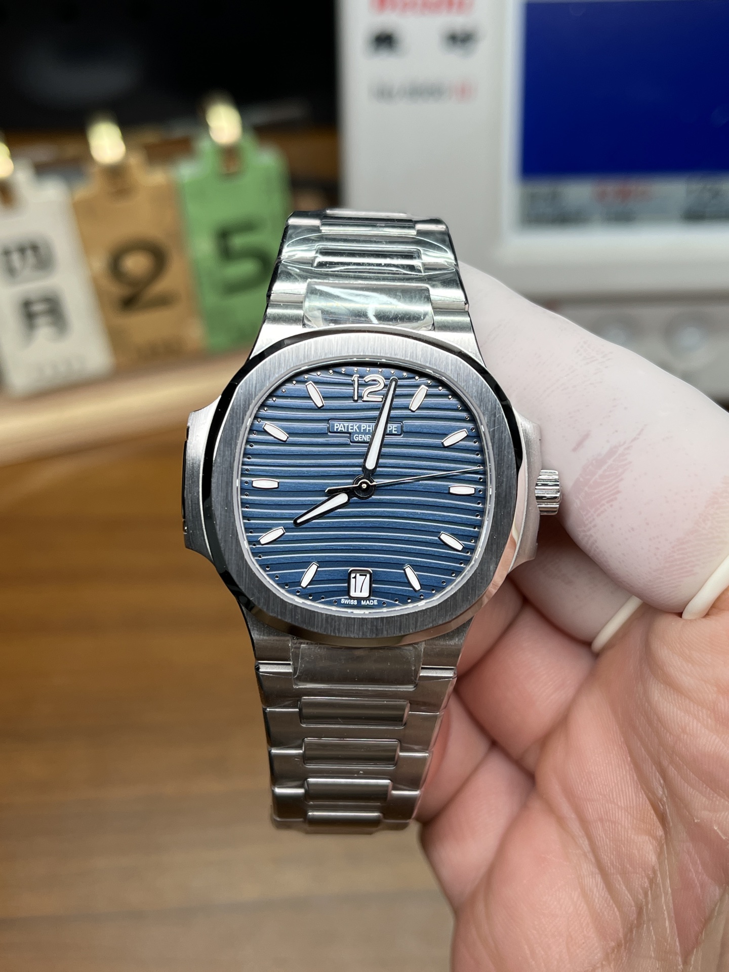 Patek Philippe Nautilus replica blue dial close front view with polished bezel and bracelet