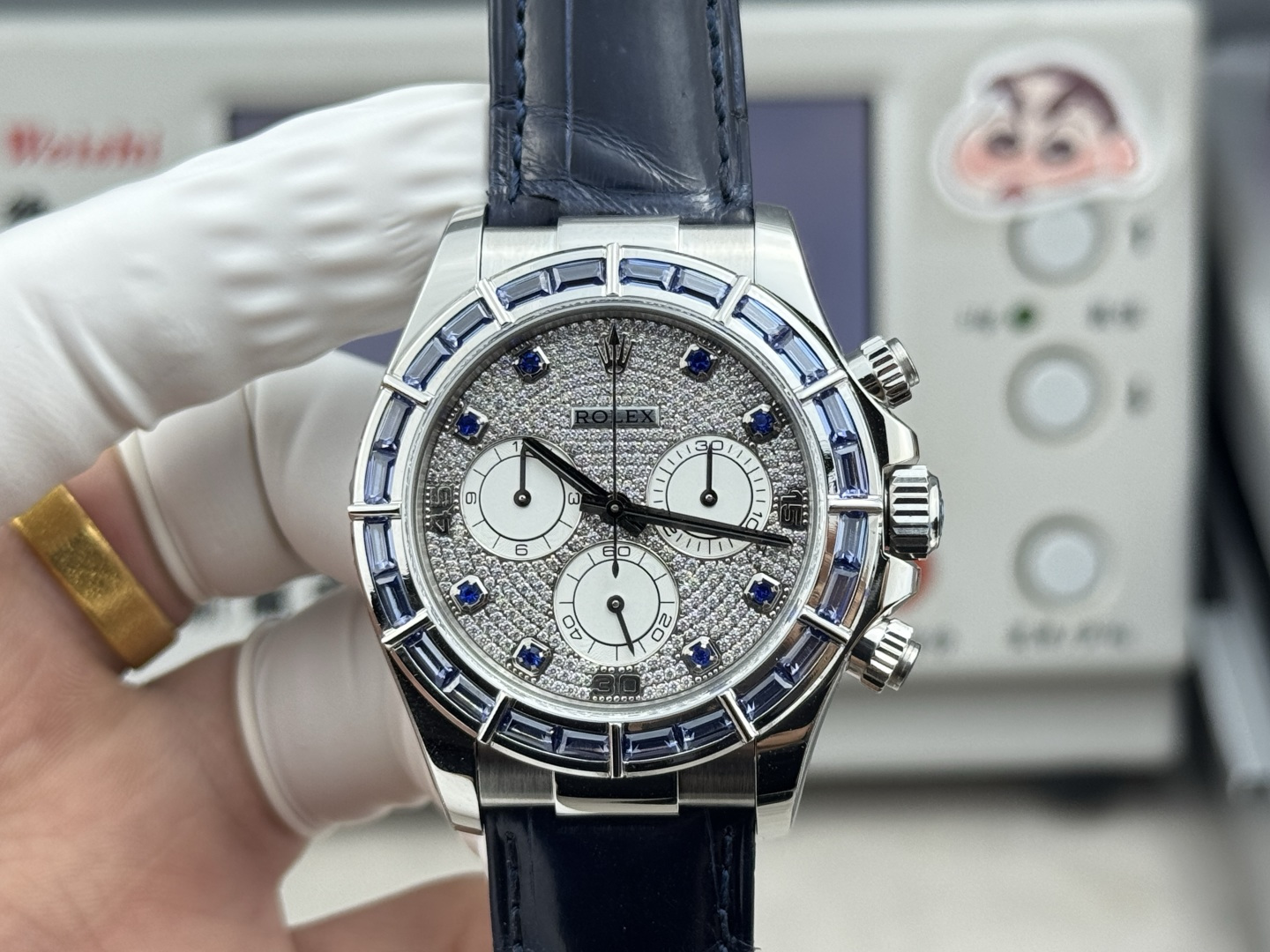 Front view of Rolex Daytona replica with diamond style dial blue hour markers and blue baguette bezel