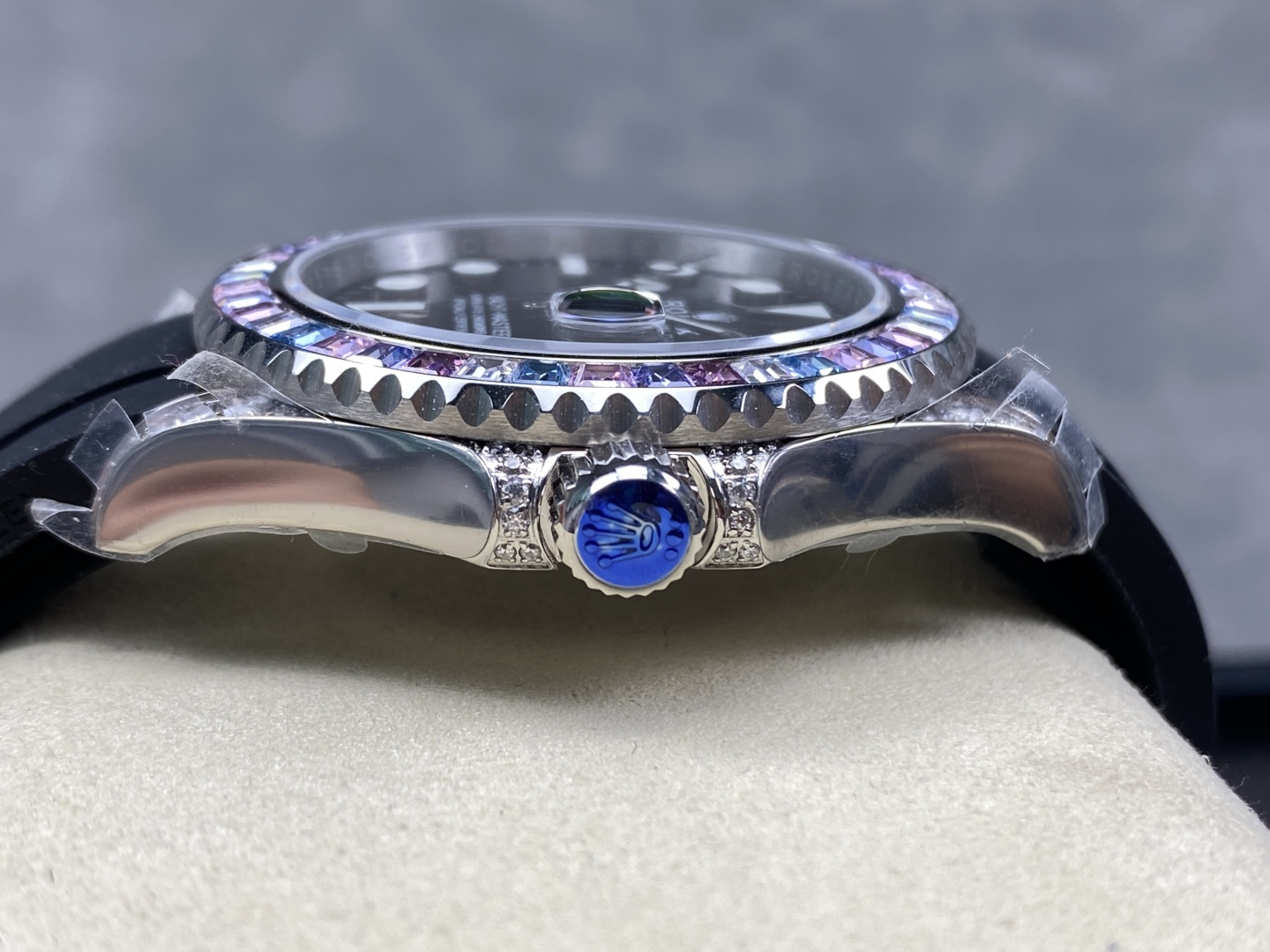 Rolex replica case profile with crown guards and blue gemstone crown