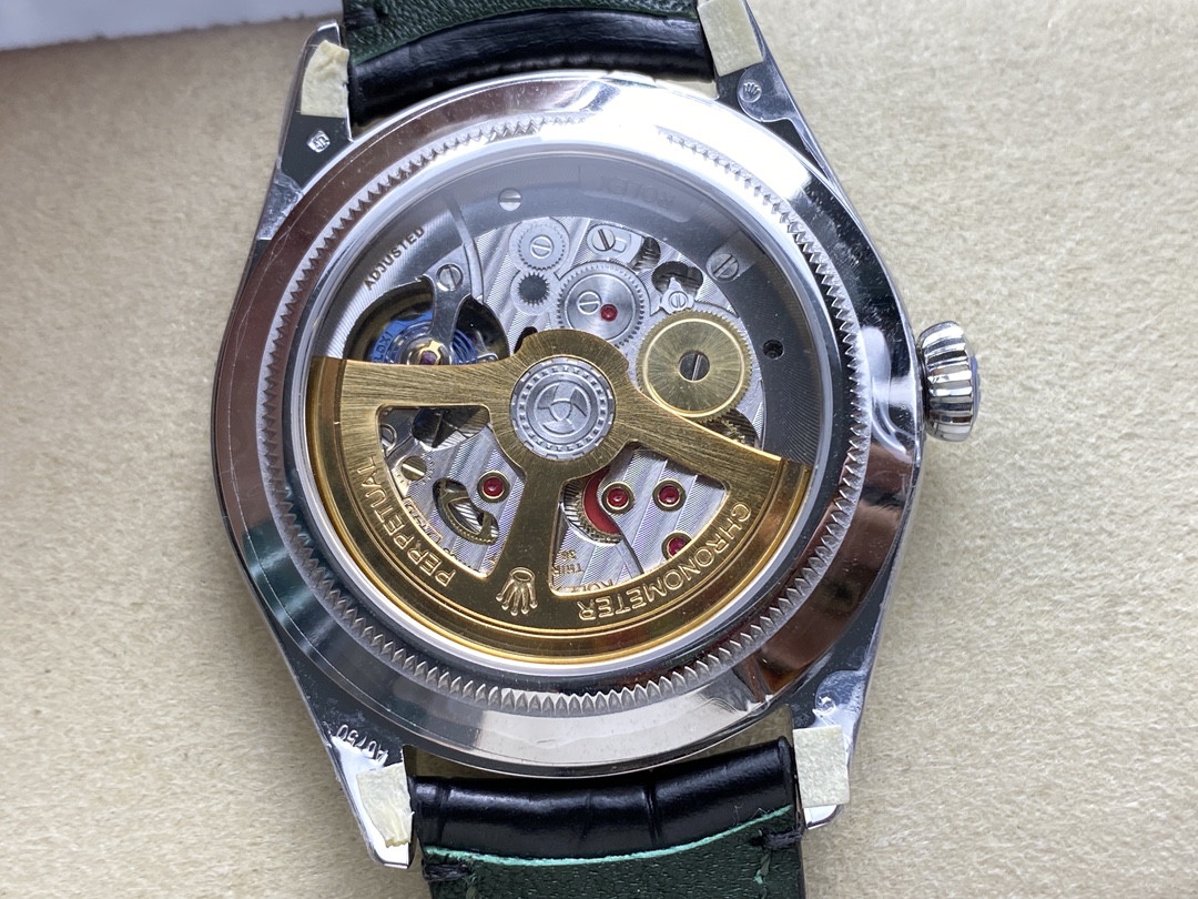Sapphire caseback showing 7140 clone movement with gold rotor and perlage finish