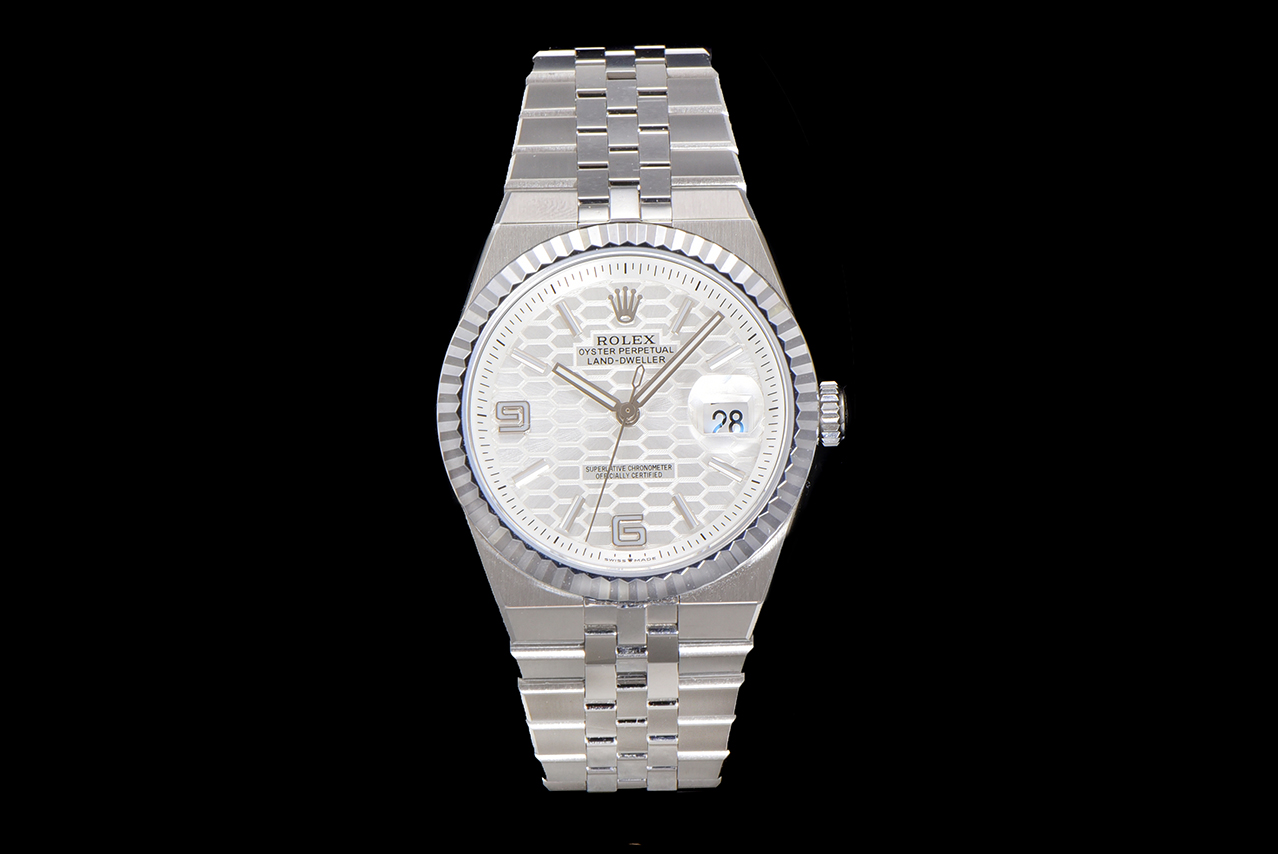 Full front view of a silver faux Rolex Land-Dweller watch on black background