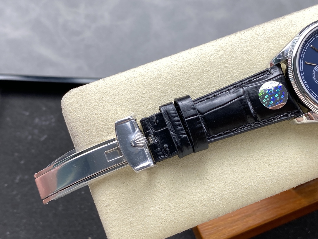 Replica Rolex folding clasp with crown logo and black leather strap detail
