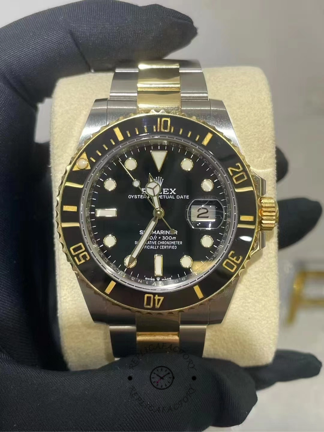 Front view of a Rolex Submariner 126613LN-0002 used after two years of use, with black dial and gold details on the bezel