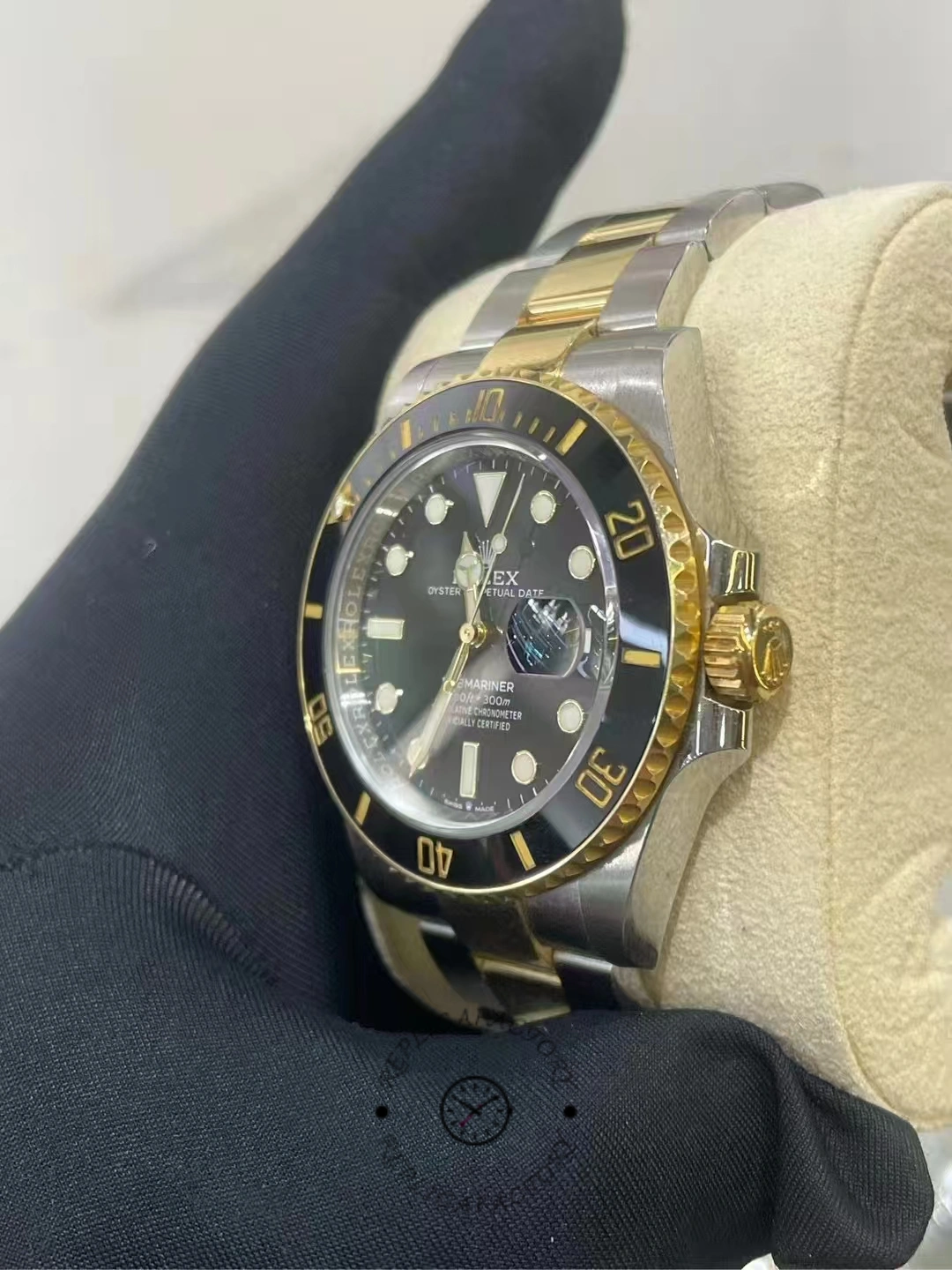Side view of a used Rolex Submariner 126613LN-0002, showing the gold crown and ceramic bezel.