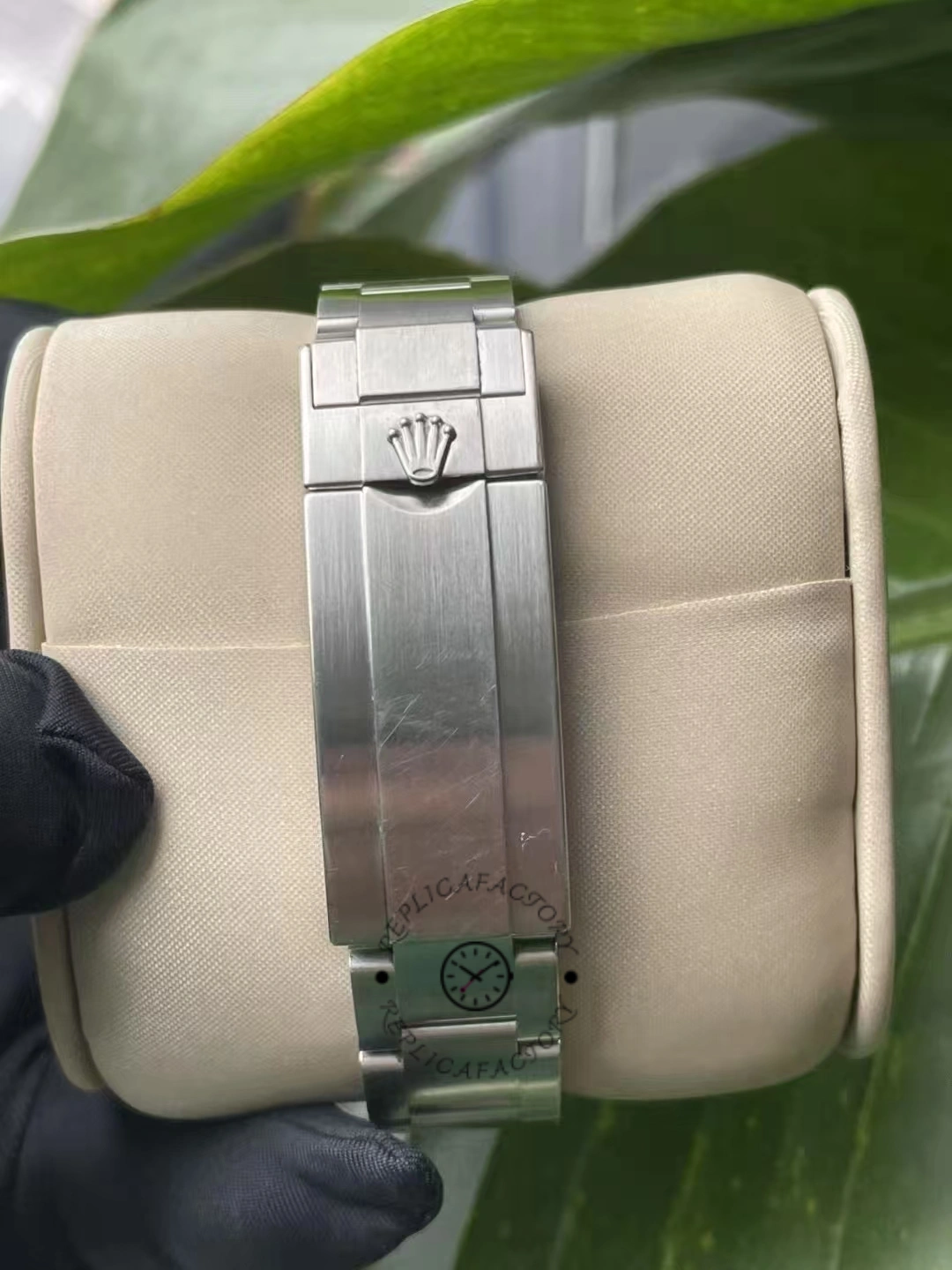 Rear closure of the Rolex Submariner Date 116610LV with Rolex crown engraved on a brushed steel surface.