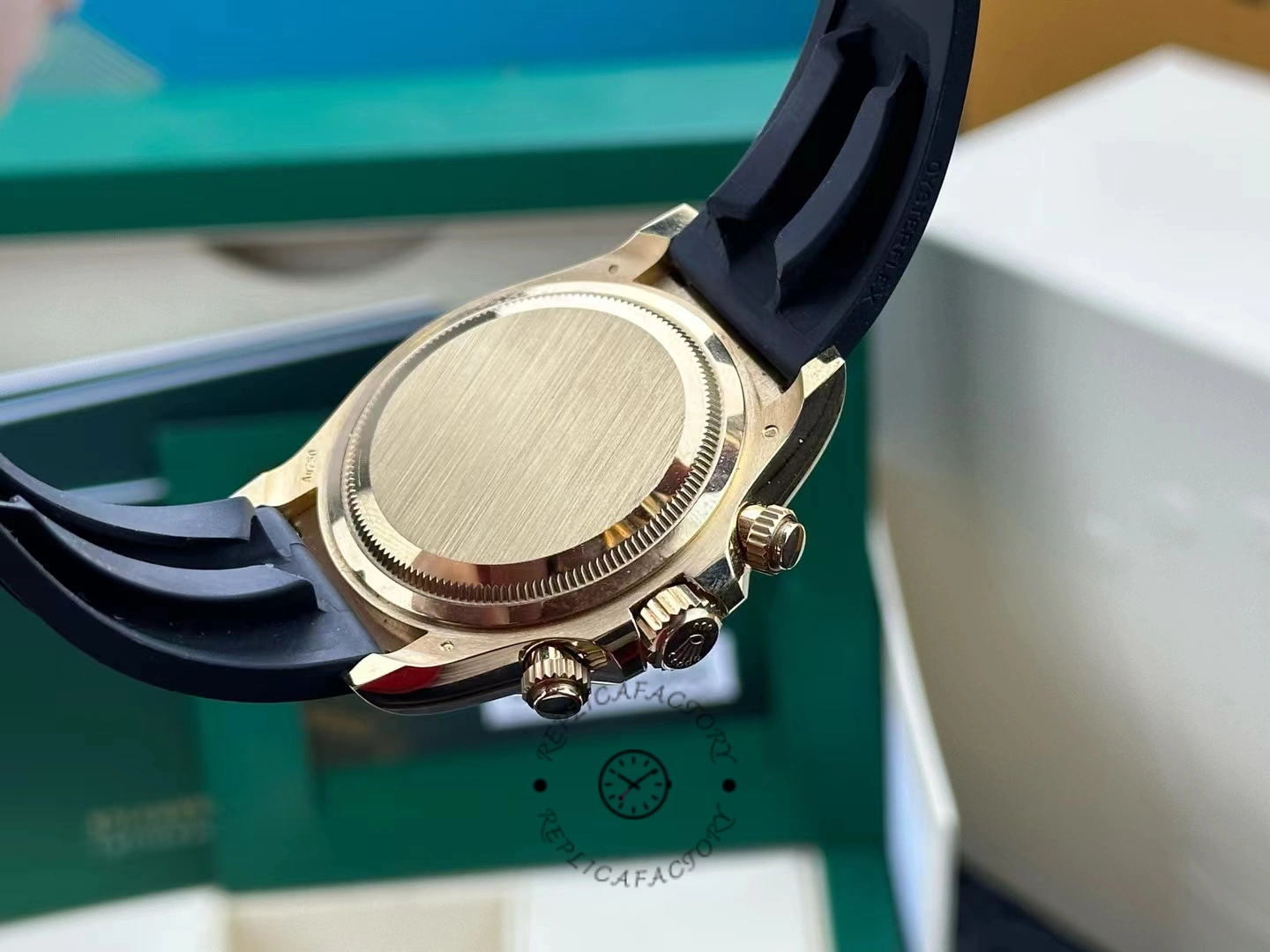 Rear view of the case of the Rolex Daytona 126518LN showing the brushed gold background and screwed crown.