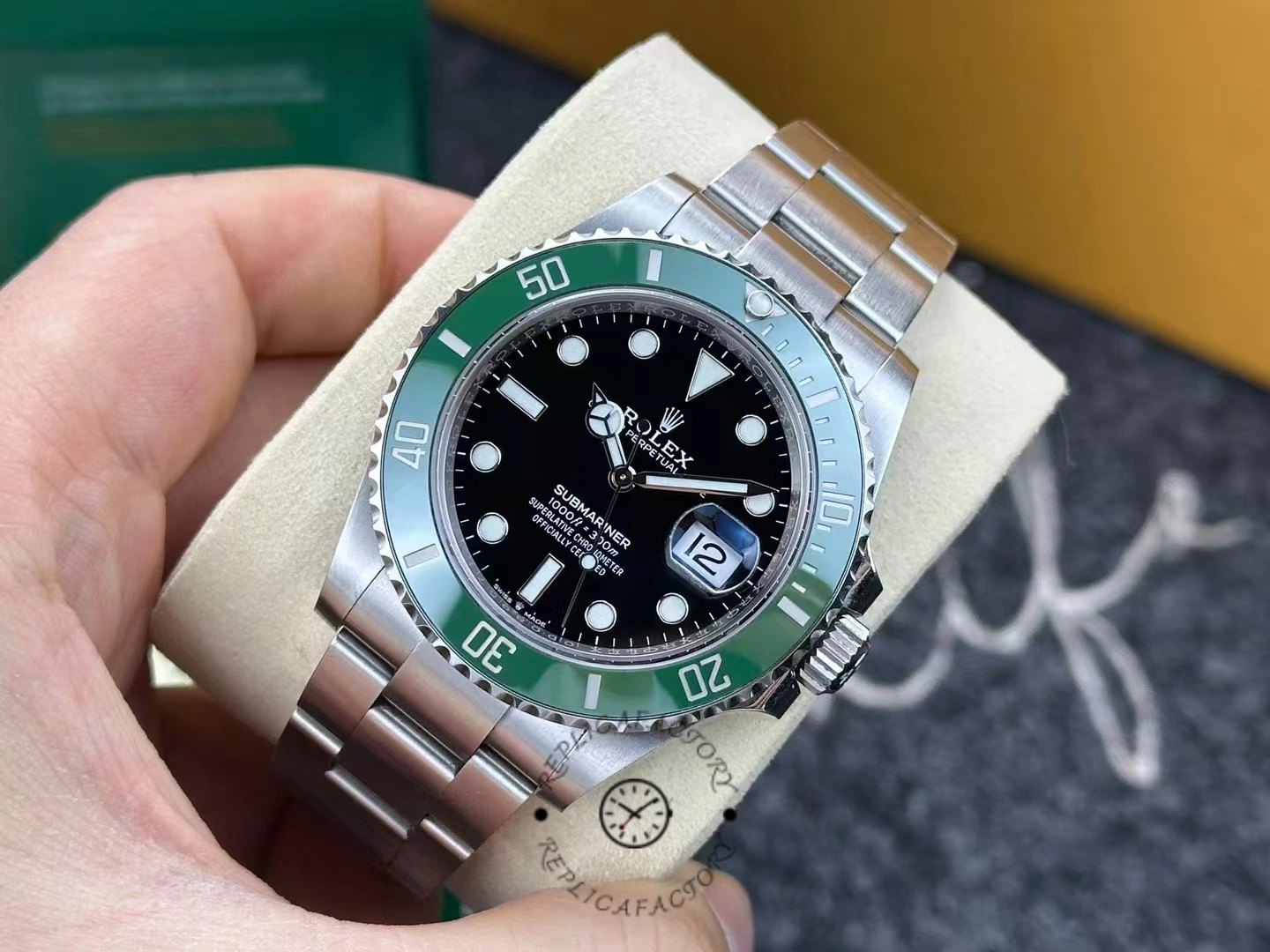 Rolex Submariner 126610LV used for 3 years, green bezel and black dial, close-up.