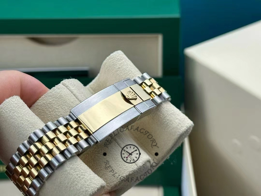 Closure view of Rolex GMT-Master II 126713GRNR-0001 showing Rolex crown logo and polished center links.