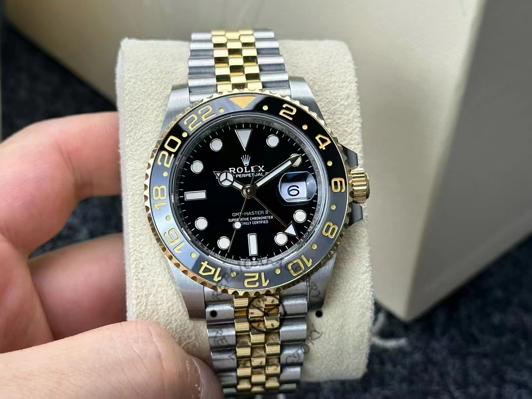 Real photo of the Rolex GMT-Master II 126713GRNR-0001 with black dial, gold bezel and Jubilee bracelet.
