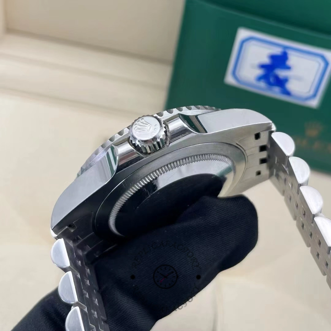 Side angle of the Rolex GMT-Master II 126710BLRO showing the crown with the Rolex logo and the polished case.