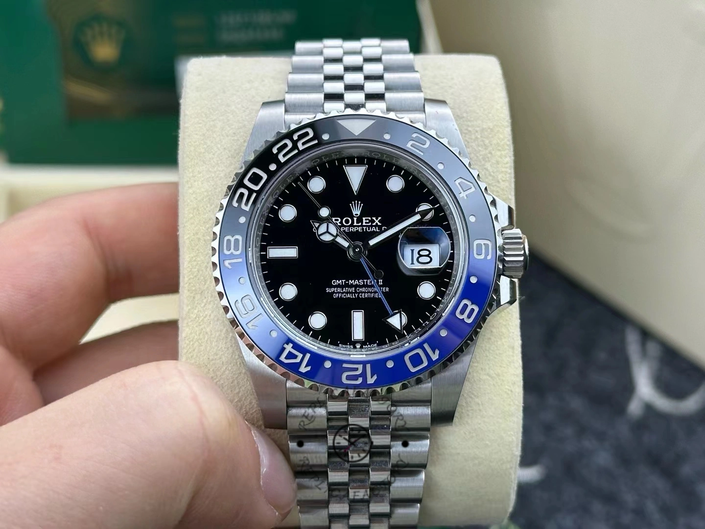 Front view of second-hand Rolex GMT-Master II 126710BLNR-0002 after one year of use, with blue-black ceramic bezel and black dial.